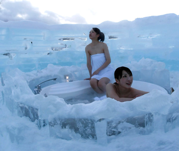 Women bathe at an outdoor bathroom of the ice hotel.